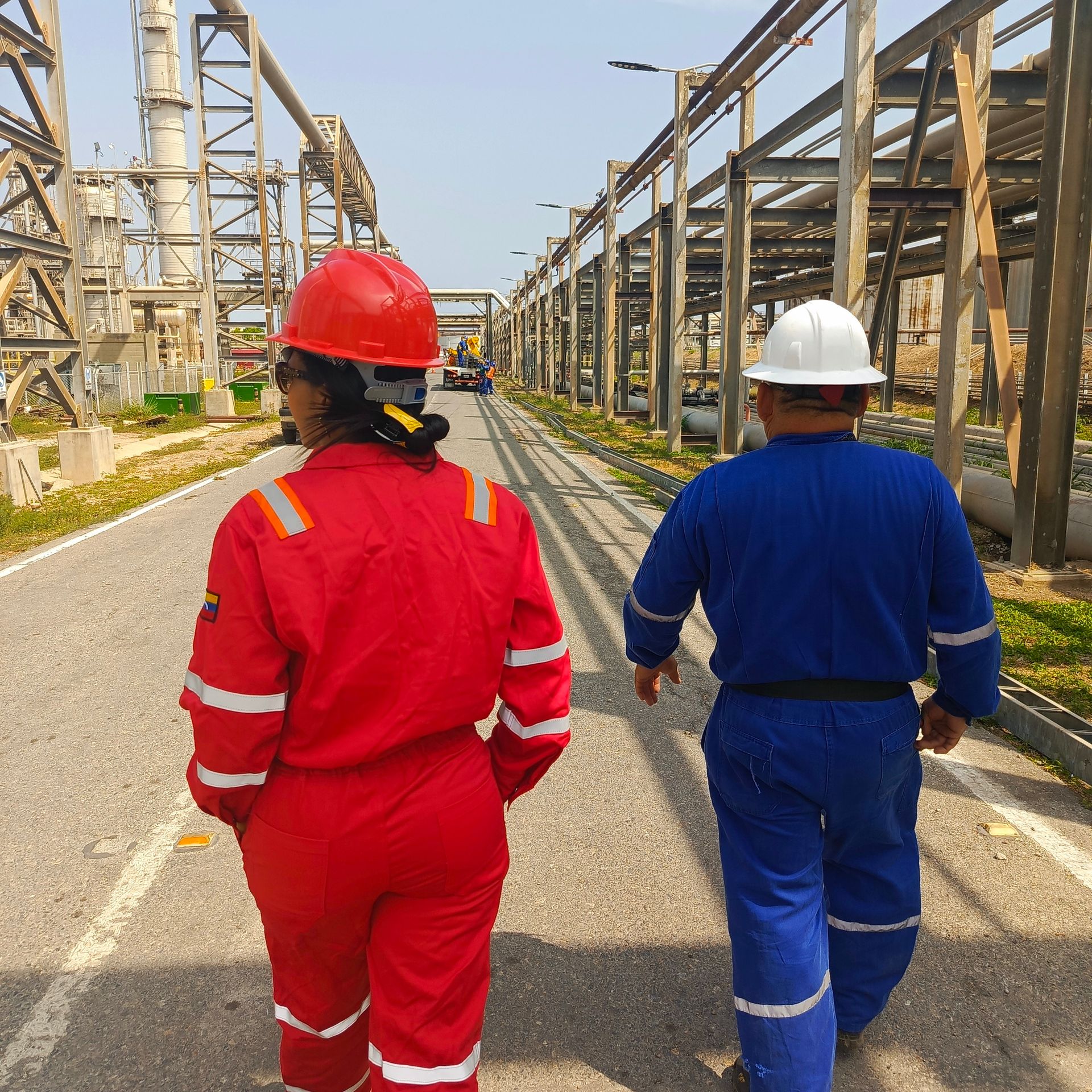Health and safety on site: engineer or supervisor in PPE reviewing paperwork on a checklist before work proceeds